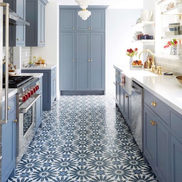 art deco apartment with blue kitchen with blue and white tiles