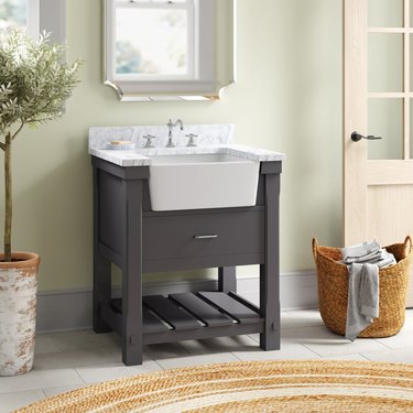 Slate gray country bathroom vanity with apron front sink and Carrara marble top