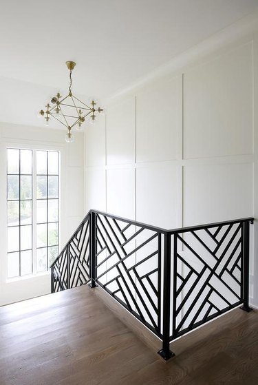 geometric pattern modern stair railing with gold ceiling light