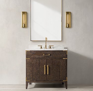 Wood country bathroom vanity with brass hardware in modern space