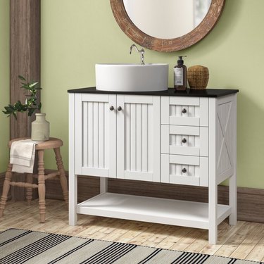 White shiplap country bathroom vanity with cabinets and drawers in green bathroom