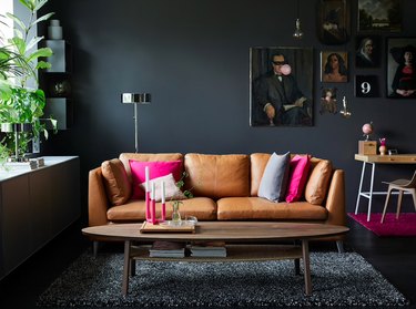 black living room with gallery wall and leather sofa