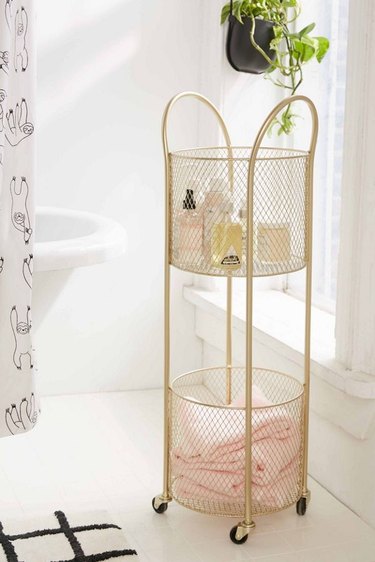 small bathroom storage ideas with  rollable gold metal storage cart