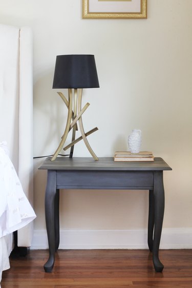 Chalk painted end table styled in bedroom