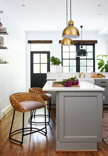 kitchen island ideas for small kitchens with brass pendant lights and wicker chairs
