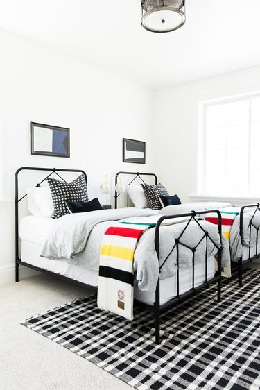 Kids' minimalist bedroom with black and white decor and flag wall art