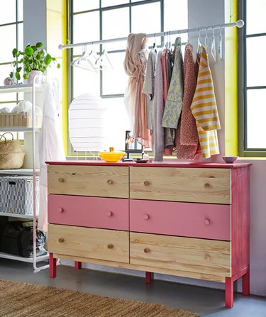 IKEA bedroom idea with a long idea dresser with DIY clothing rack hung above it