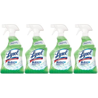 four green bottles of lysol disinfectant spray