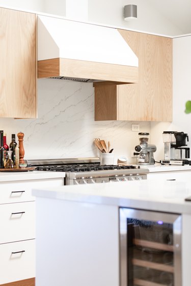 White and natural wood custom hood, wood cabinets.