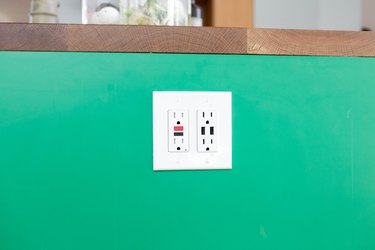close up of kitchen electric outlet on green background