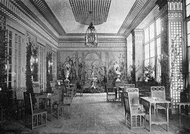 black and white photograph of an interior with tables and chairs