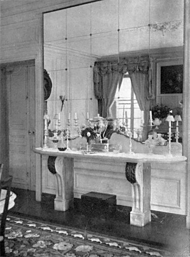 black and white photograph of room with large mirror wall