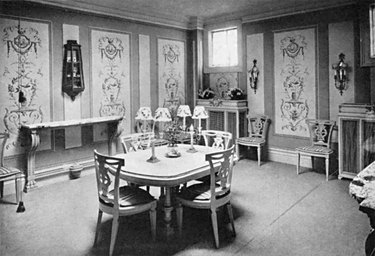 black and white photograph of a dining room interior with patterned walls