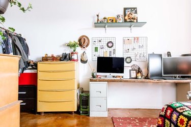 colorful bedroom desk area with storage and hanging shelf