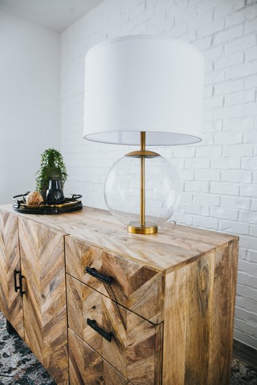 Minimalist lighting clear glass table lamp with wooden dresser