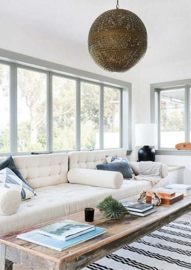 boho coastal living room with cream built-in sofa, ethnic details