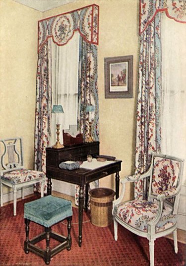 image of seating area with patterned chair and curtains