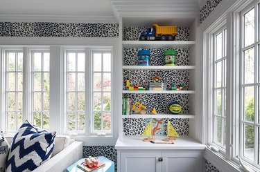 animal print modern wallpaper in family room with white molding