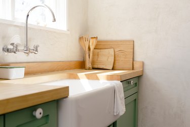 wall-mount faucet, farmhouse sink and butcher block kitchen countertop