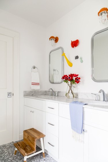 Red bathroom mirror lighting ideas in bathroom with pattern floor tile