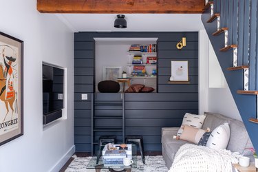 rustic basement ideas with with dark blue shiplap and colorful wall art