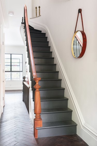 painted stairs with gray steps and riser and wood banister