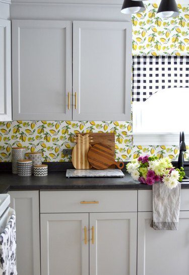 kitchen wallpaper idea  with lemon print on backsplash and white cabinets