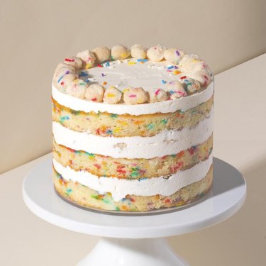 milk bar birthday cake on white cake stand