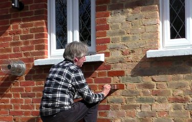 Man applying brick stain