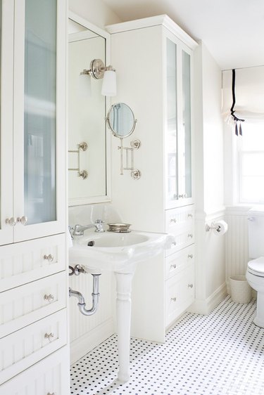 white bathroom idea with mosaic floor tile and pedestal sink
