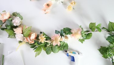 Gluing flowers to garland.