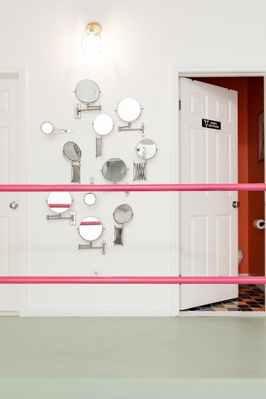 Bright pink painted stair rails in hallway
