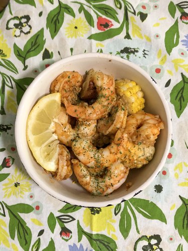 patterned tea towel with bowl with shrimp dish inside