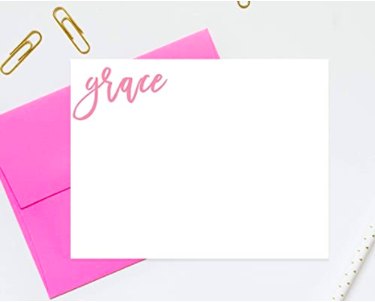pink cursive writing of the name grace on a white postcard