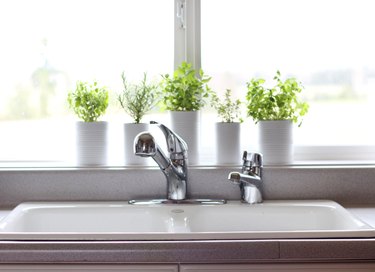 kitchen window idea with DIY herb garden in cans