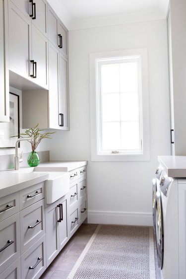 Taupe color paint in small laundry room with farmhouse sink