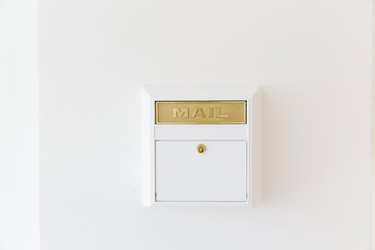 gold and white mail box