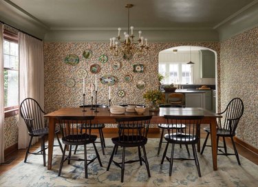 dining room with traditional home decor like patterned wallpaper