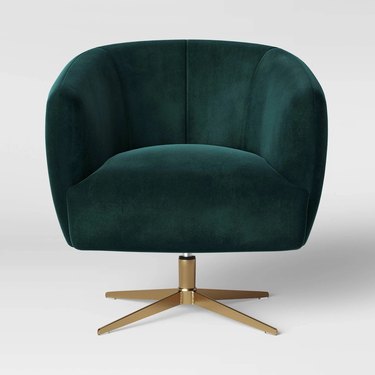 Emerald green rounded velvet swivel chair with brushed gold base