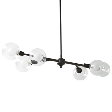 Black mid-century spoke chandelier with eight arms on same plane and clear globe lights