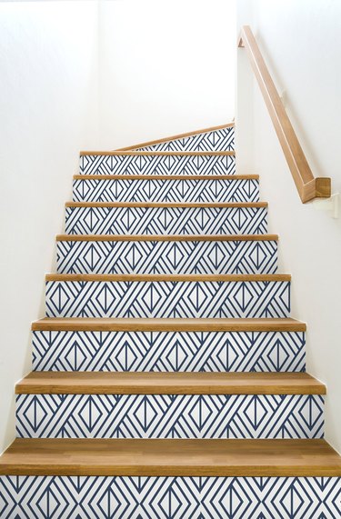 white staircase with geometric blue and white stairs wallpaper