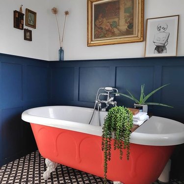 bathroom design idea with brightly painted clawfoot tub and blue board and batten wainscot