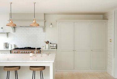 White kitchen design with copper pendant lights