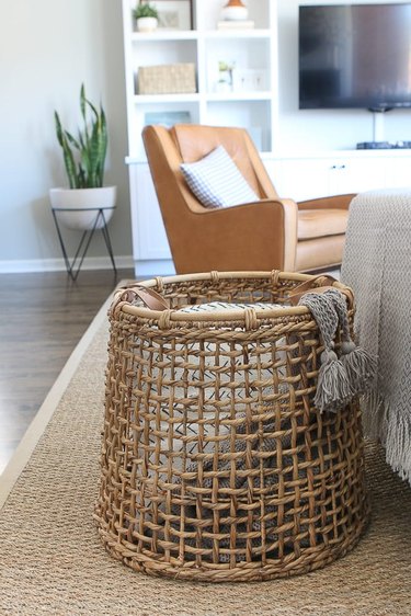 Living room storage ideas with woven basket for blankets