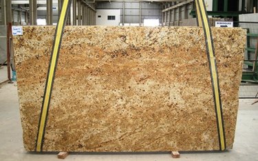 Unfinished granite slab in warehouse.