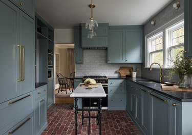 blue kitchen with brick floors