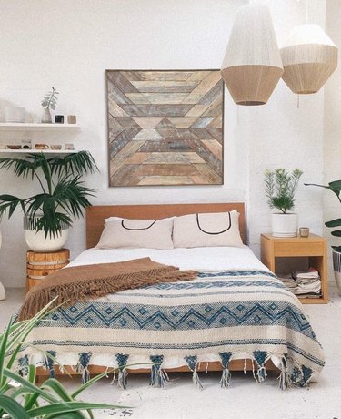 masculine boho bedroom with wooden wall art