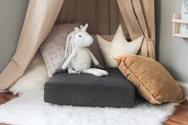 Pile of pillows with stuffed unicorn