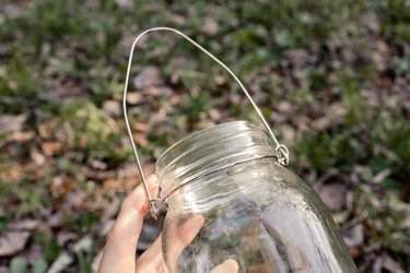 Metal hanging hook attached to top of mason jar