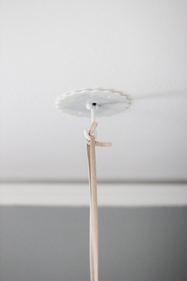 Adhesive hook mounted on ceiling